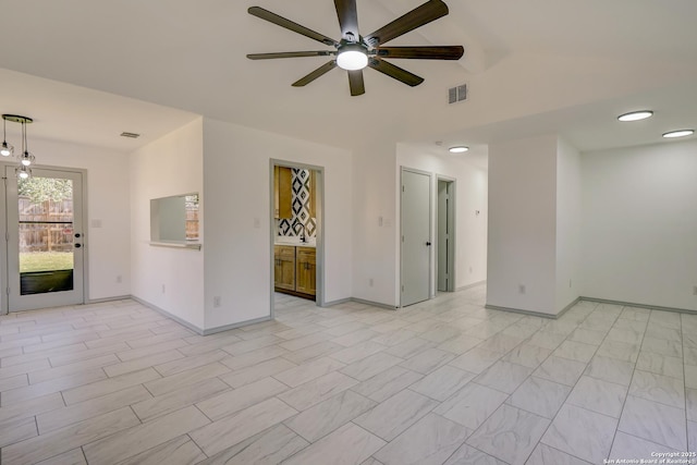 unfurnished room featuring a ceiling fan, visible vents, and baseboards