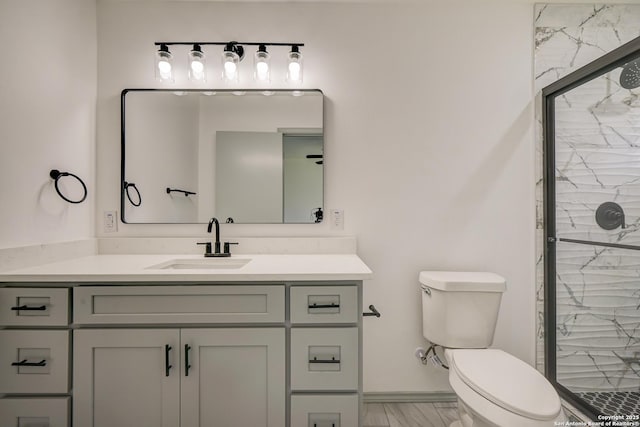 full bath with toilet, a shower stall, and vanity