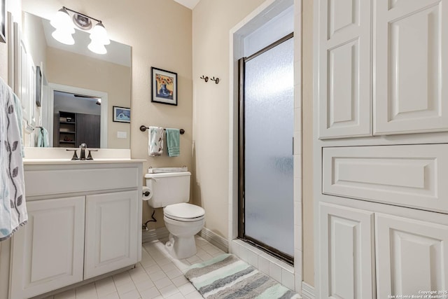 bathroom with baseboards, toilet, a shower with door, tile patterned floors, and vanity