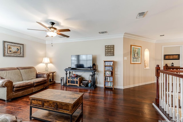 living room with crown molding, visible vents, and hardwood / wood-style floors