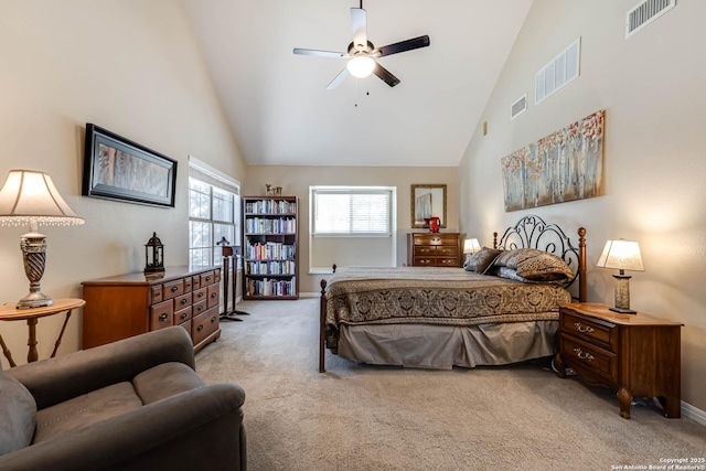 bedroom featuring high vaulted ceiling, visible vents, and light colored carpet