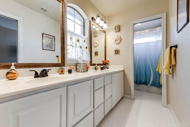 full bathroom with double vanity, a sink, visible vents, and tile patterned floors