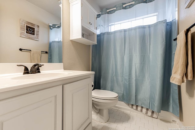 bathroom featuring tile patterned flooring, curtained shower, vanity, and toilet