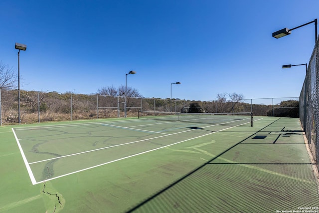 view of sport court with fence