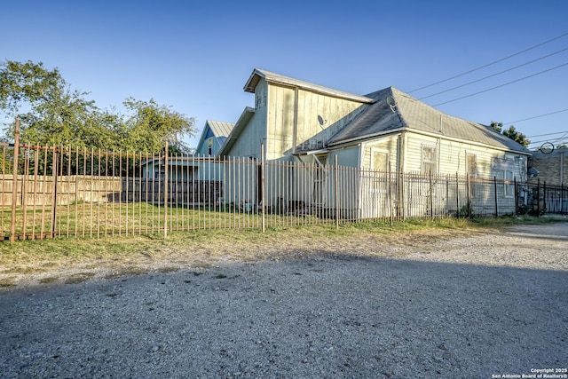 view of side of property featuring fence