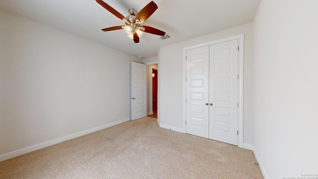 unfurnished bedroom with carpet floors, visible vents, and baseboards