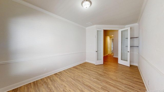 empty room featuring light wood-style flooring, baseboards, crown molding, and french doors