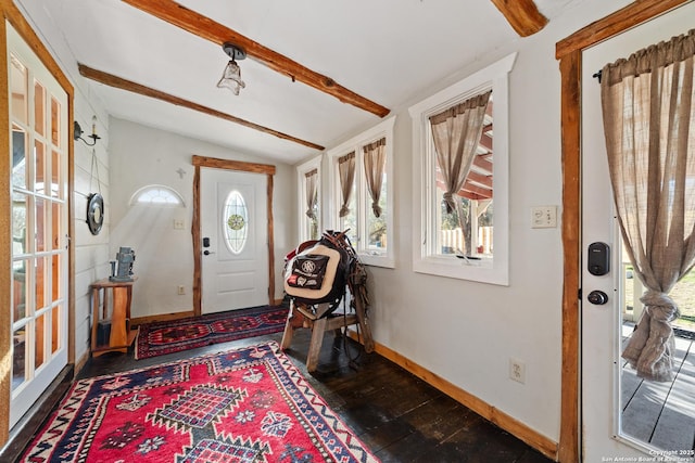 foyer featuring lofted ceiling with beams, dark wood finished floors, and baseboards