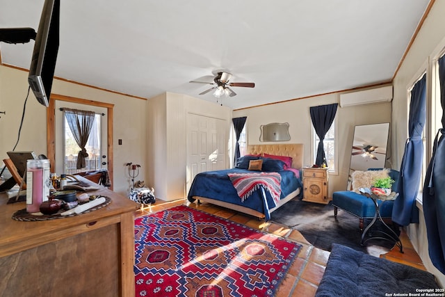 bedroom with ceiling fan, an AC wall unit, a closet, and crown molding