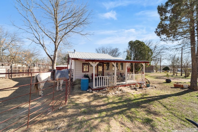 exterior space featuring covered porch and fence