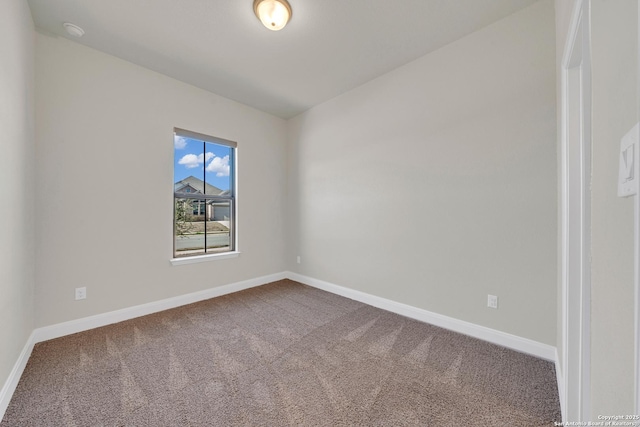 unfurnished room with carpet flooring and baseboards