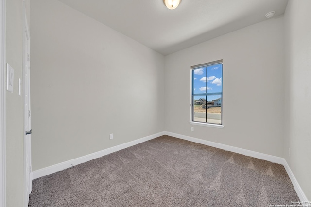 carpeted empty room with baseboards