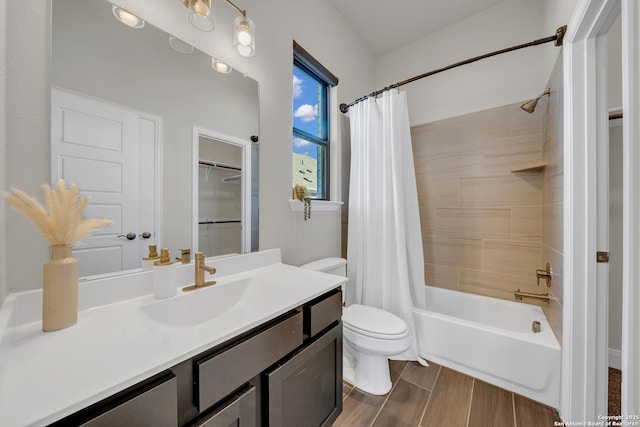 bathroom featuring wood finish floors, shower / bath combo, vanity, and toilet