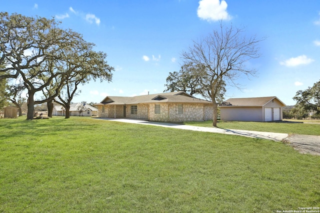 view of front of home featuring stone siding, an outdoor structure, a front lawn, and concrete driveway