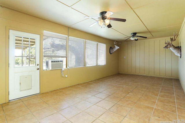 spare room with a wealth of natural light, light tile patterned floors, and cooling unit