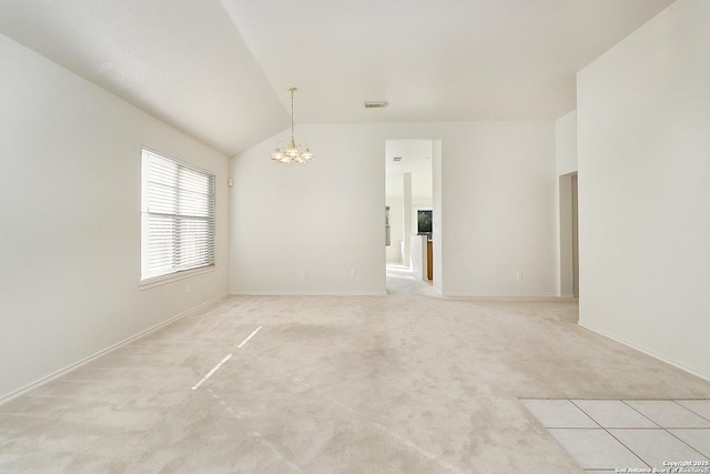 unfurnished room with baseboards, visible vents, vaulted ceiling, light colored carpet, and a chandelier