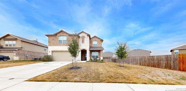 traditional home with driveway, an attached garage, fence, central air condition unit, and brick siding