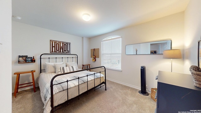 carpeted bedroom featuring baseboards