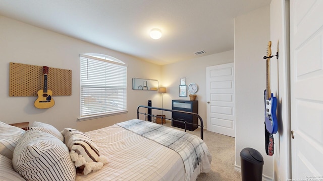 bedroom with visible vents and carpet flooring