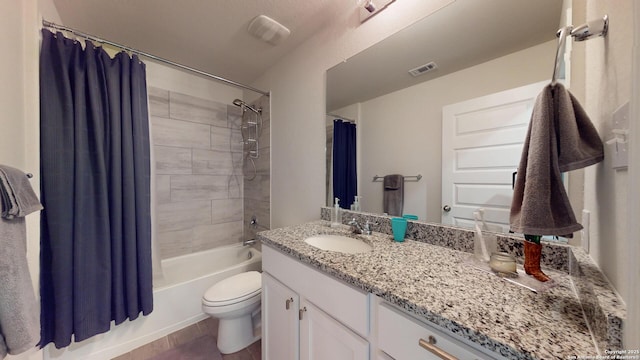 full bathroom with shower / tub combo, visible vents, vanity, and toilet