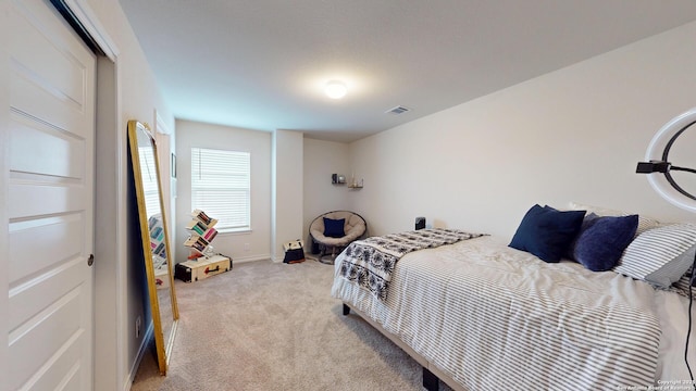 bedroom featuring light carpet and visible vents