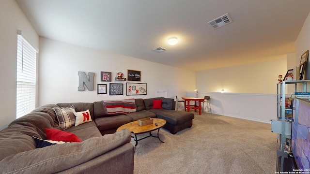 living area with carpet flooring, visible vents, and baseboards