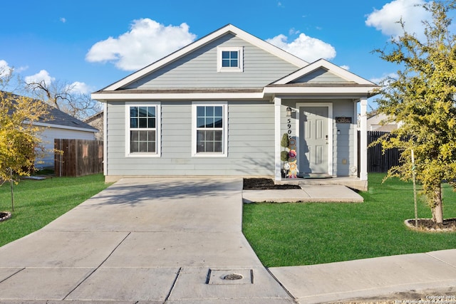 bungalow-style house featuring a front yard and fence