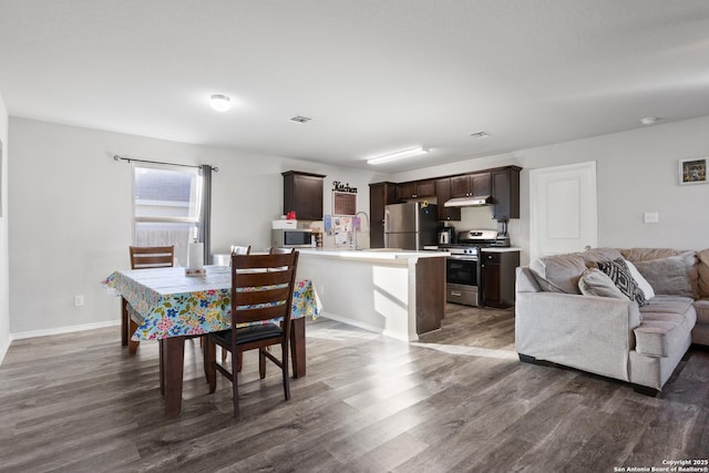 dining area with dark wood-type flooring, visible vents, and baseboards