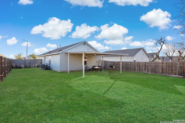 rear view of property featuring a lawn, cooling unit, and a fenced backyard