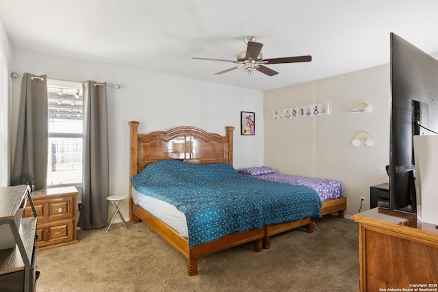 bedroom with light carpet, ceiling fan, and baseboards