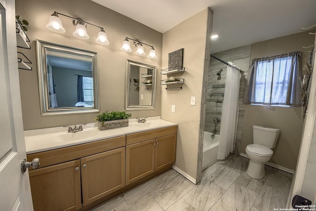 full bathroom featuring toilet, marble finish floor, double vanity, and a sink