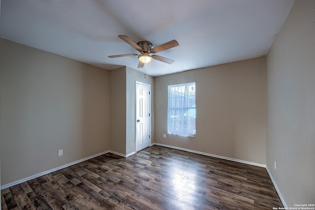 empty room with a ceiling fan, baseboards, and wood finished floors