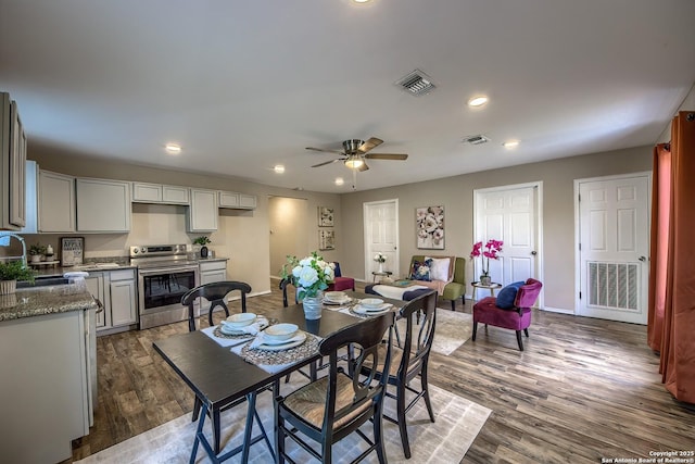 dining space featuring baseboards, visible vents, ceiling fan, wood finished floors, and recessed lighting