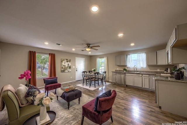 living area featuring dark wood-type flooring, recessed lighting, visible vents, and plenty of natural light