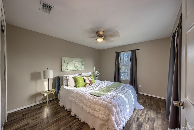 bedroom with a ceiling fan, baseboards, visible vents, and wood finished floors