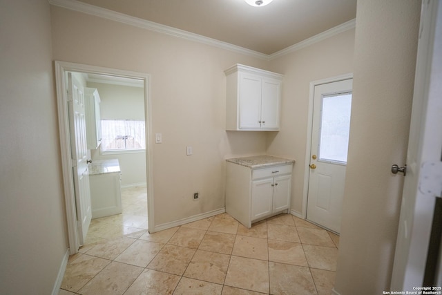 laundry room featuring a healthy amount of sunlight, light tile patterned floors, baseboards, and crown molding