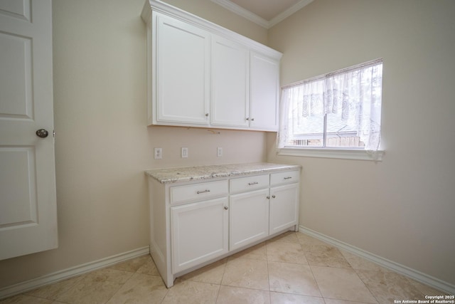 washroom featuring light tile patterned floors, baseboards, and crown molding