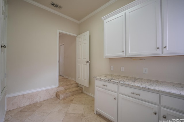 kitchen with crown molding, visible vents, white cabinets, light stone countertops, and baseboards