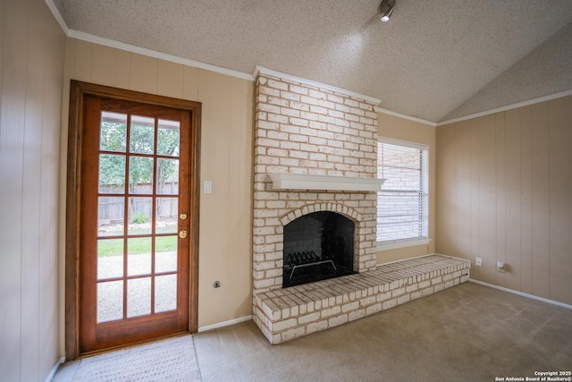 unfurnished living room featuring plenty of natural light, a brick fireplace, carpet flooring, and lofted ceiling