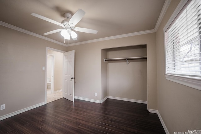 unfurnished bedroom with a closet, baseboards, and dark wood-type flooring