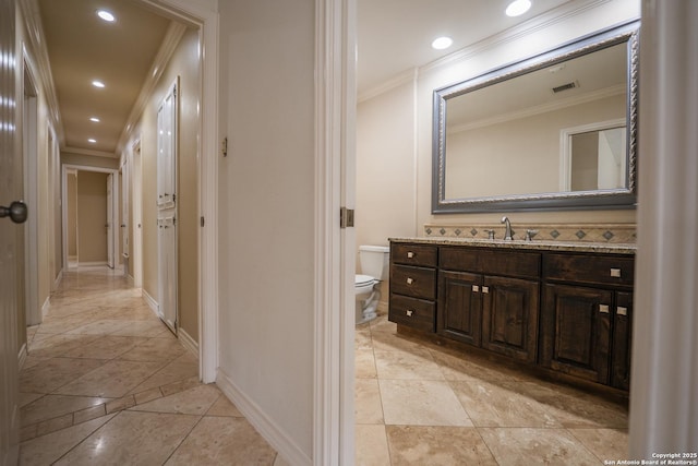 bathroom with visible vents, toilet, crown molding, vanity, and recessed lighting