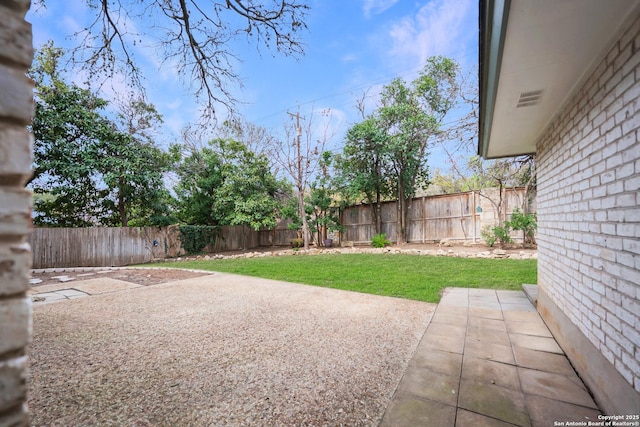 view of yard featuring a patio area and a fenced backyard