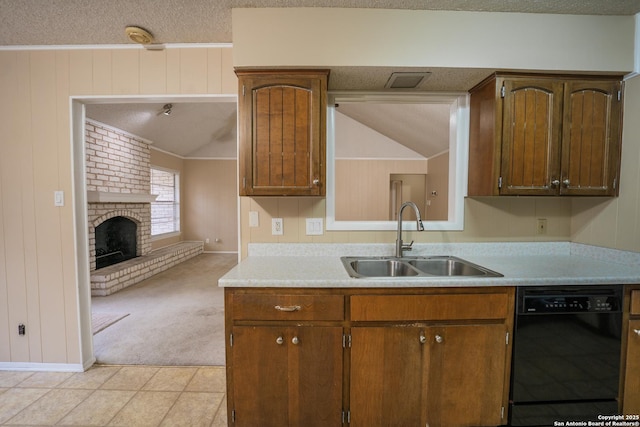 kitchen with lofted ceiling, light countertops, a brick fireplace, a sink, and dishwasher