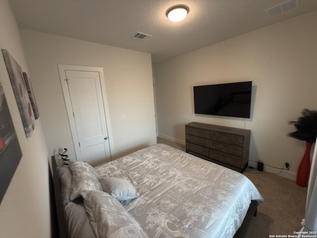 carpeted bedroom featuring visible vents and baseboards