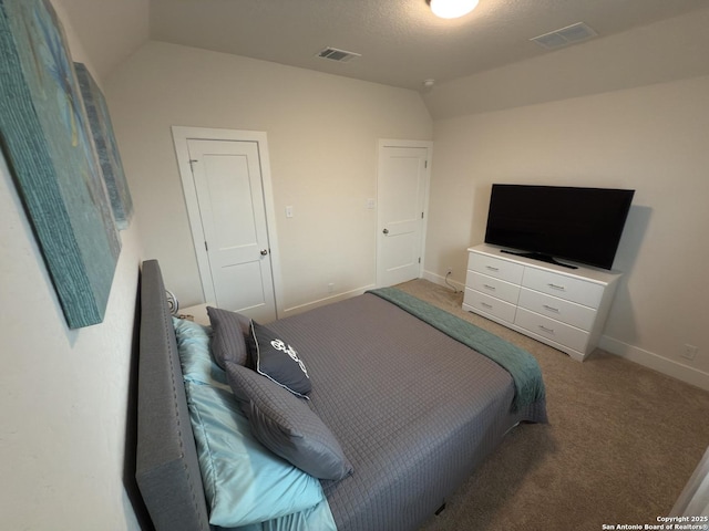 bedroom with lofted ceiling, baseboards, visible vents, and carpet flooring