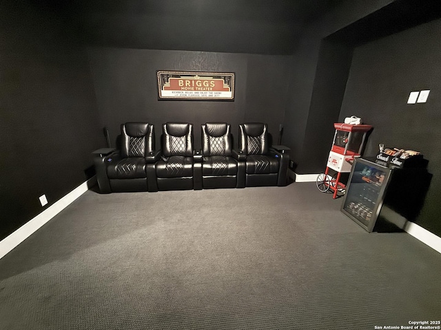 home theater room featuring baseboards and carpet flooring