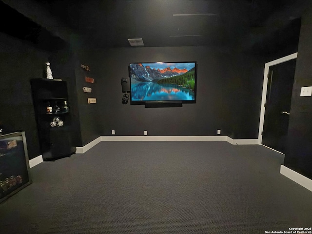 carpeted cinema room with baseboards and visible vents