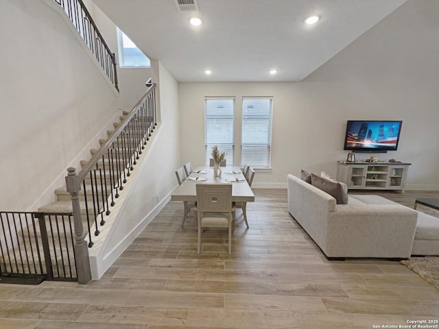 living room with recessed lighting, visible vents, stairway, light wood-style flooring, and baseboards