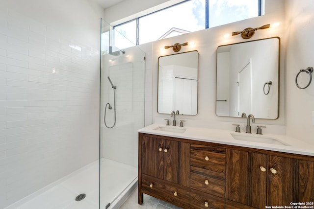 full bath with a walk in shower, double vanity, and a sink