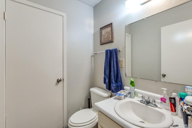 bathroom featuring toilet and vanity